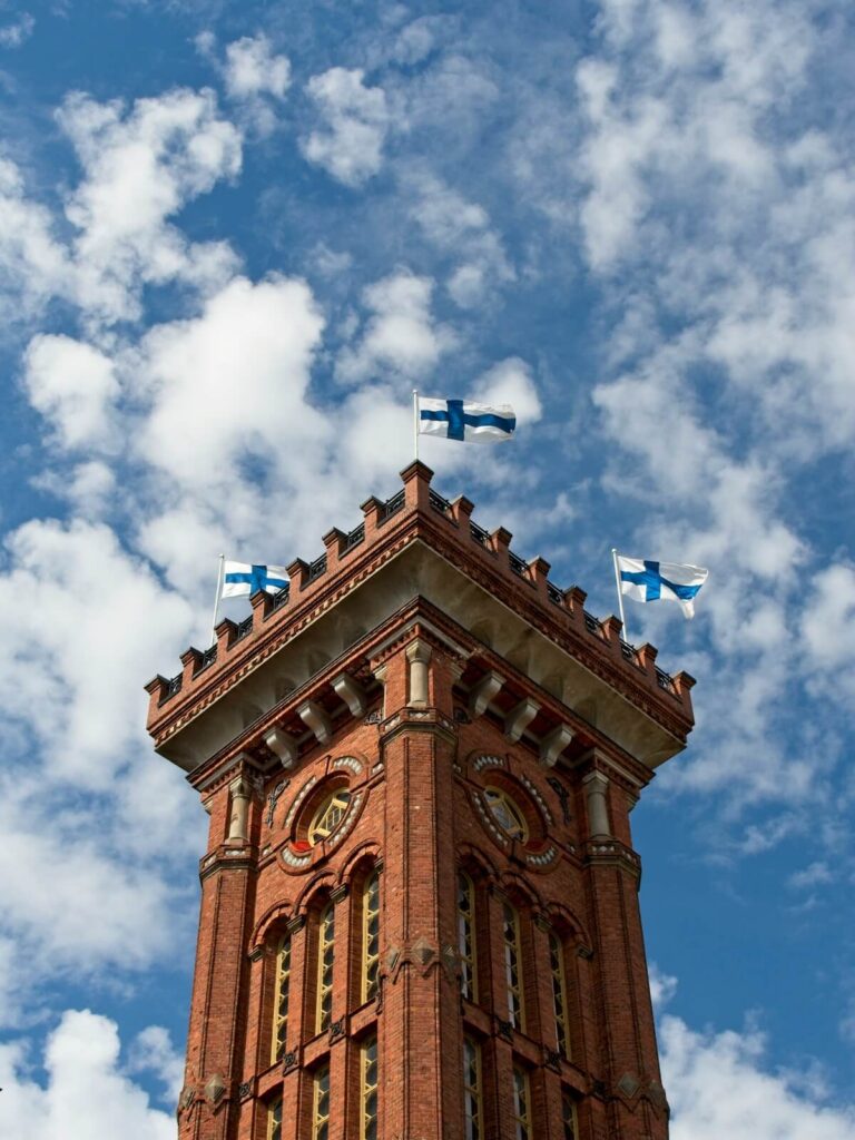 Finnish flags flying at the top of the fire station tower in Helsinki