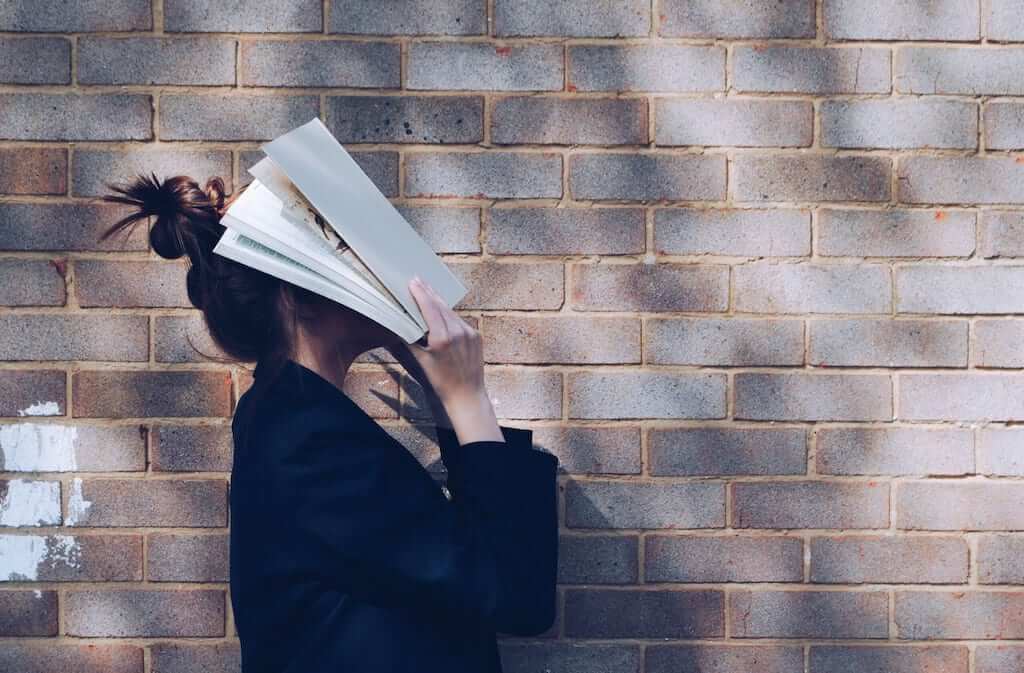 Learn Italian with book on face