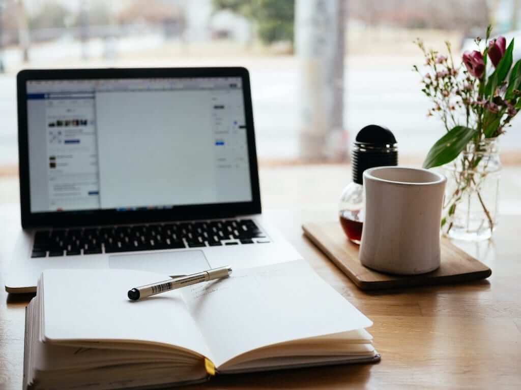 Studying with book and laptop