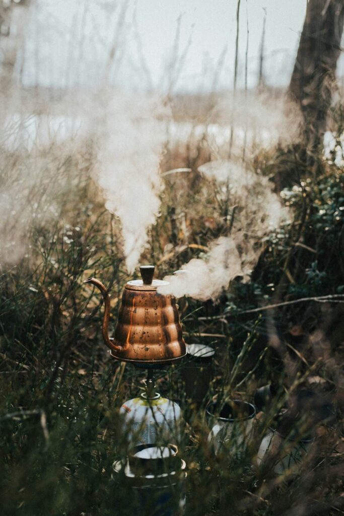 kettle with boiling water in camp ground