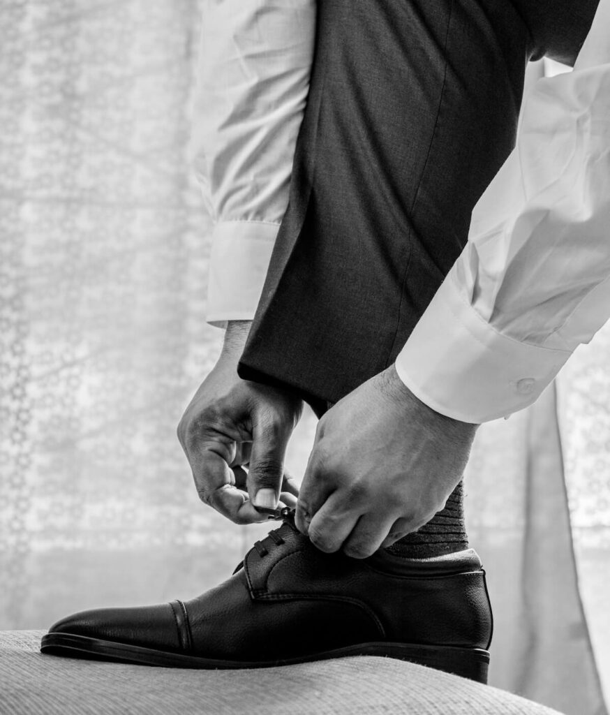 man in formal attire wearing dress shoes