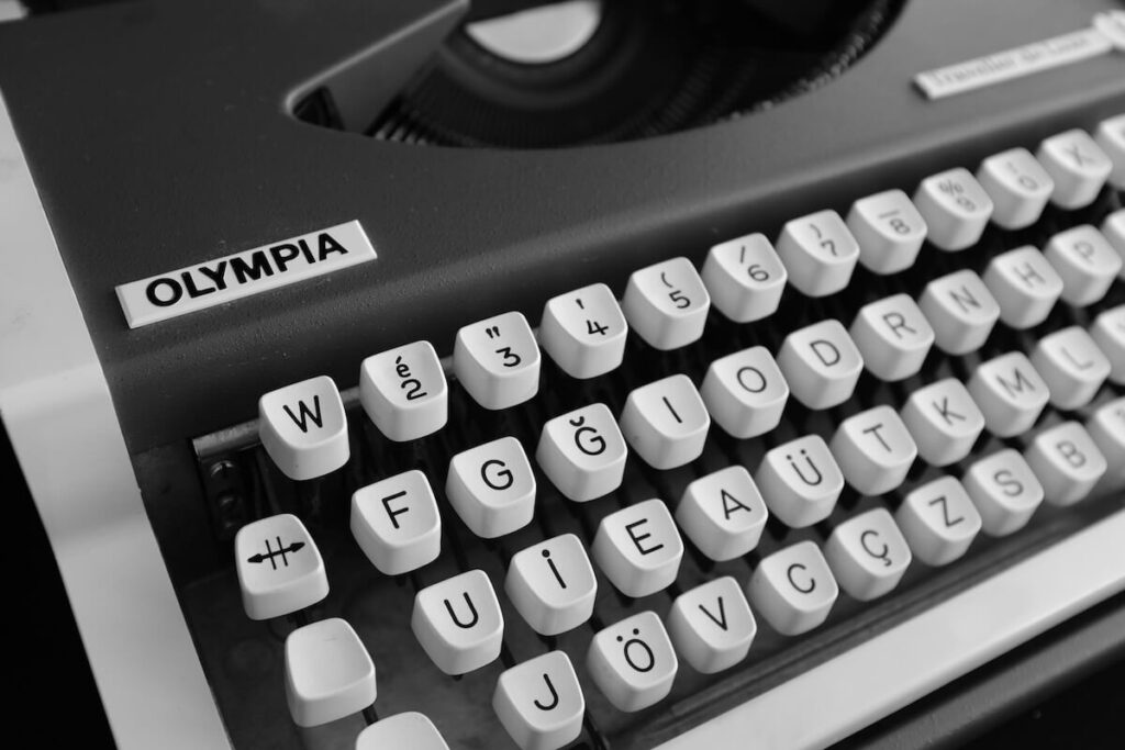 Close-up shot of an Olympia typewriter showing its German keyboard layout in black and white