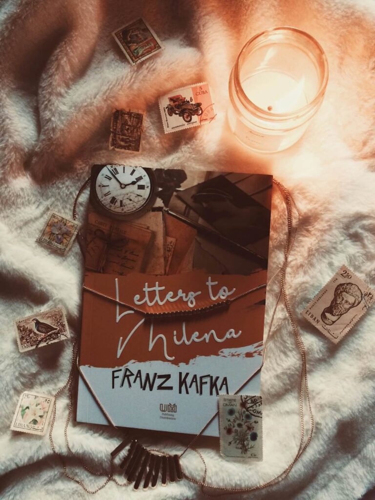 Franz Kafka's "Letters to Milena" and some random stamps on top of blanket