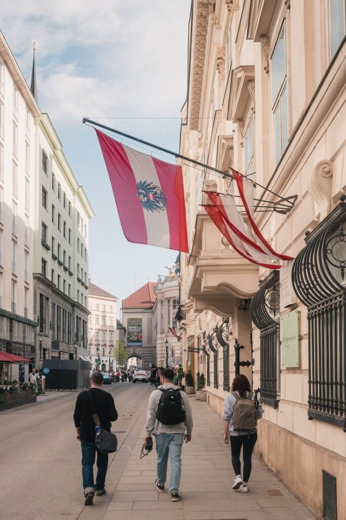 Street scene in Vienna with Austrian flag and people walking