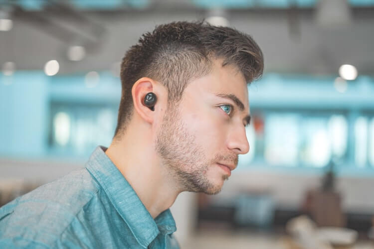 Man wearing translator earbuds