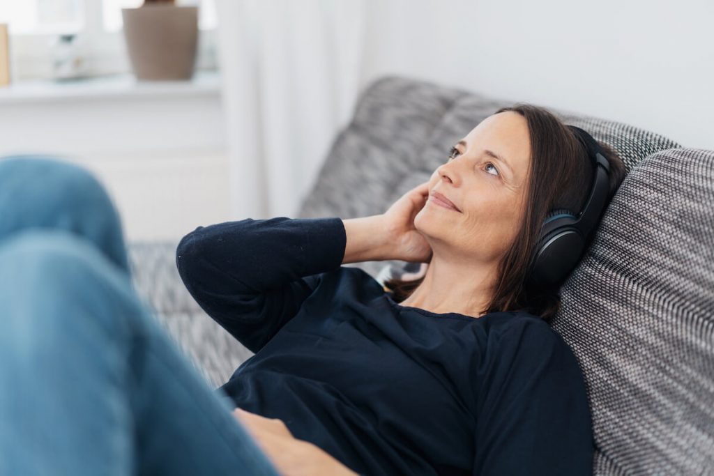 Woman listening to French podcast
