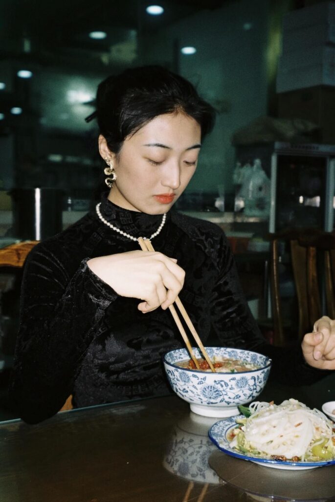 Chinese girl eating noodles