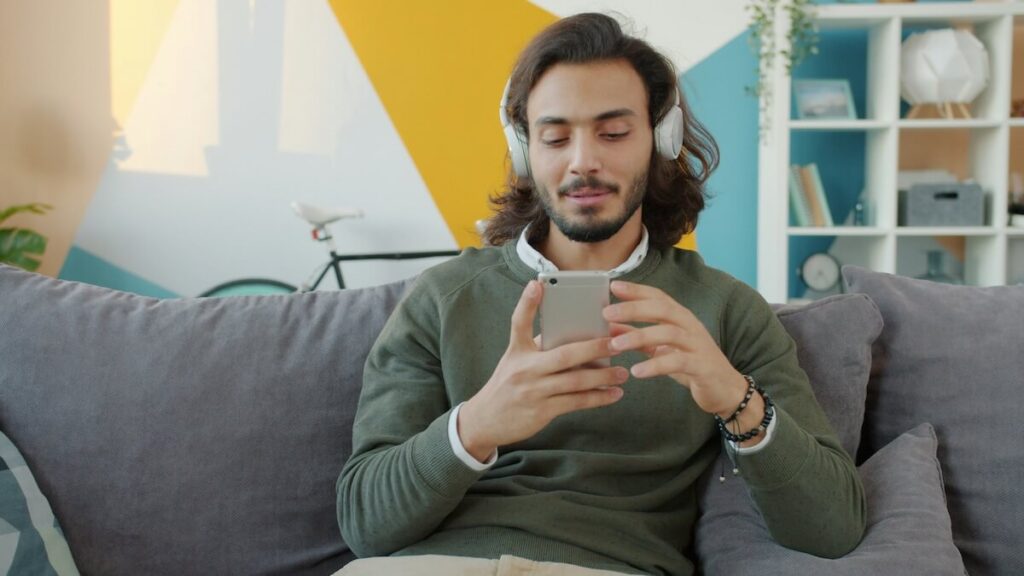man wearing headset and using phone