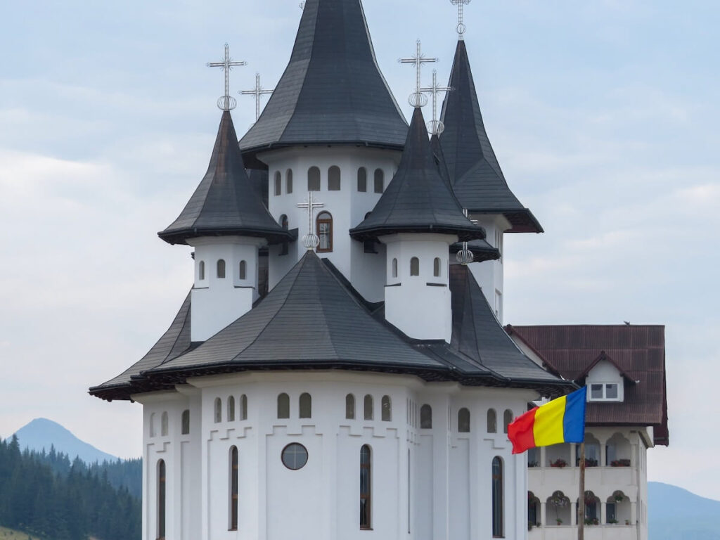 spires and Romanian flag