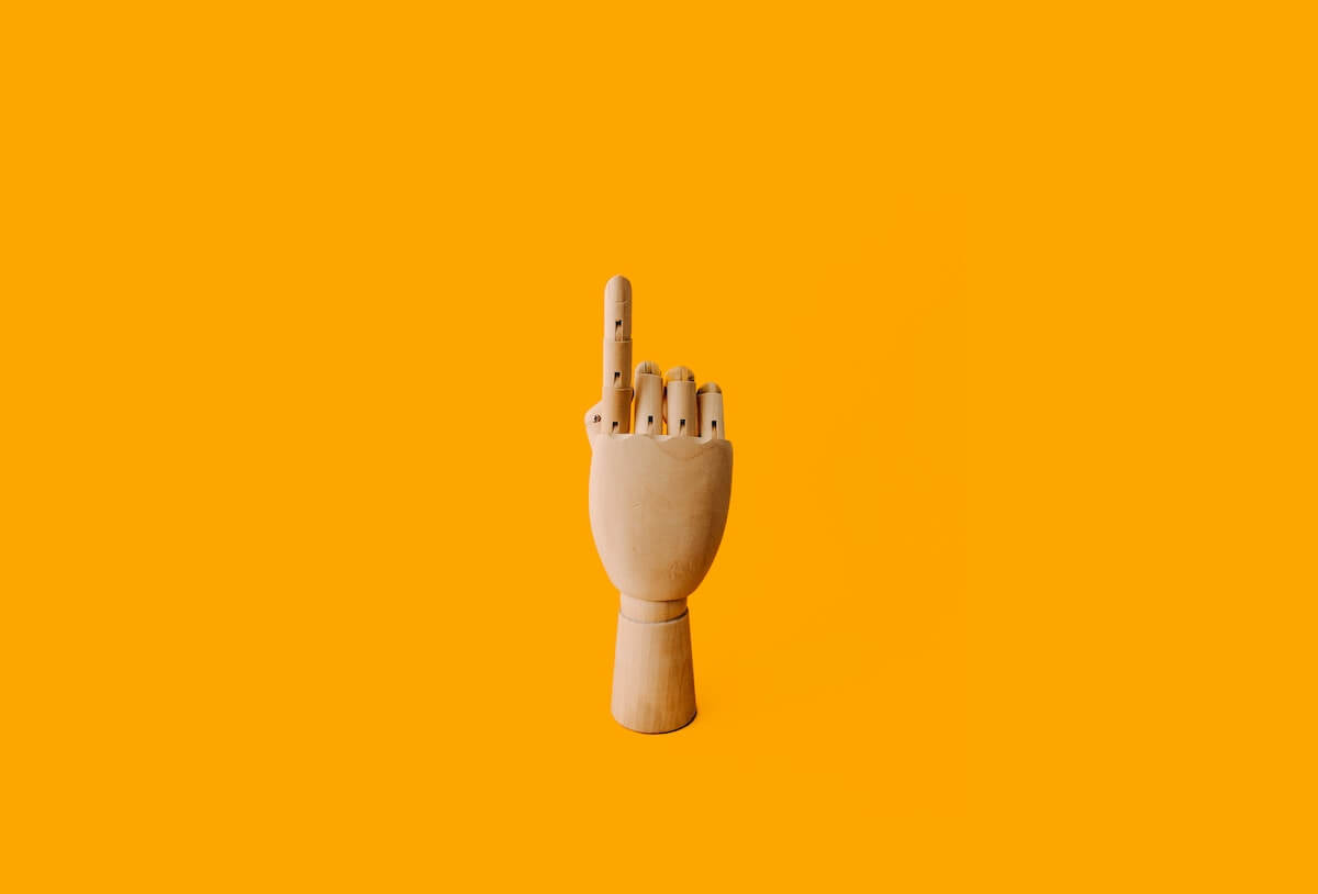 wooden-hand-with-index-finger-pointing wooden hand with index finger pointing