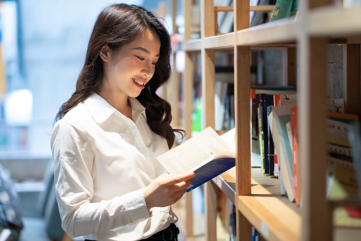 woman browsing books on library