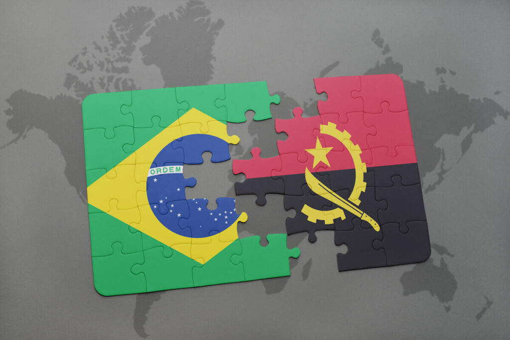 puzzle with the national flag of brazil and angola on a world map background