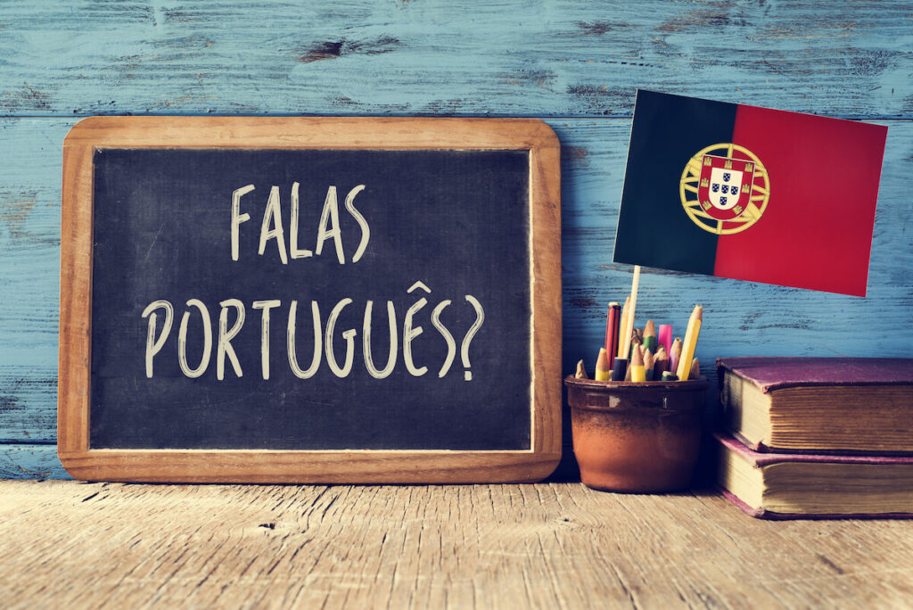 a chalkboard with the question question "falas portuges?" which means "do you speak Portuguese?"