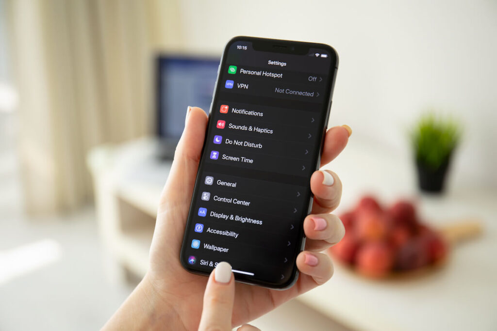 Woman hand holding phone to check settings