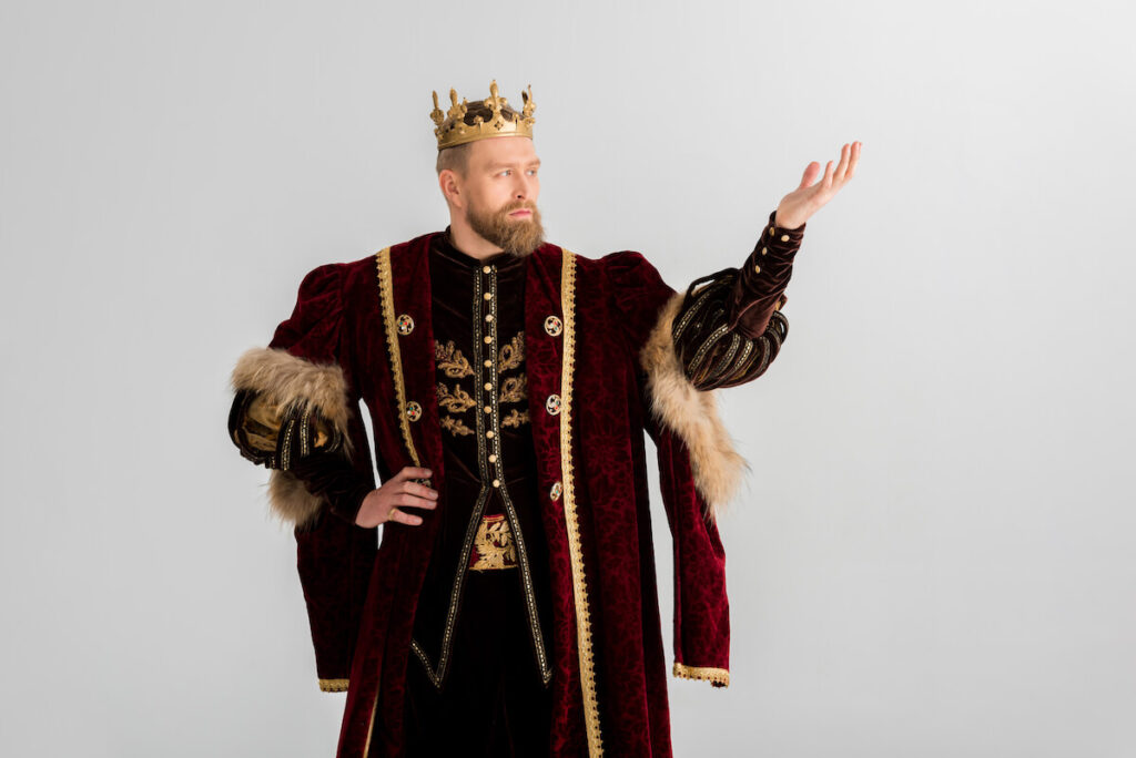 king with crown pointing with hand