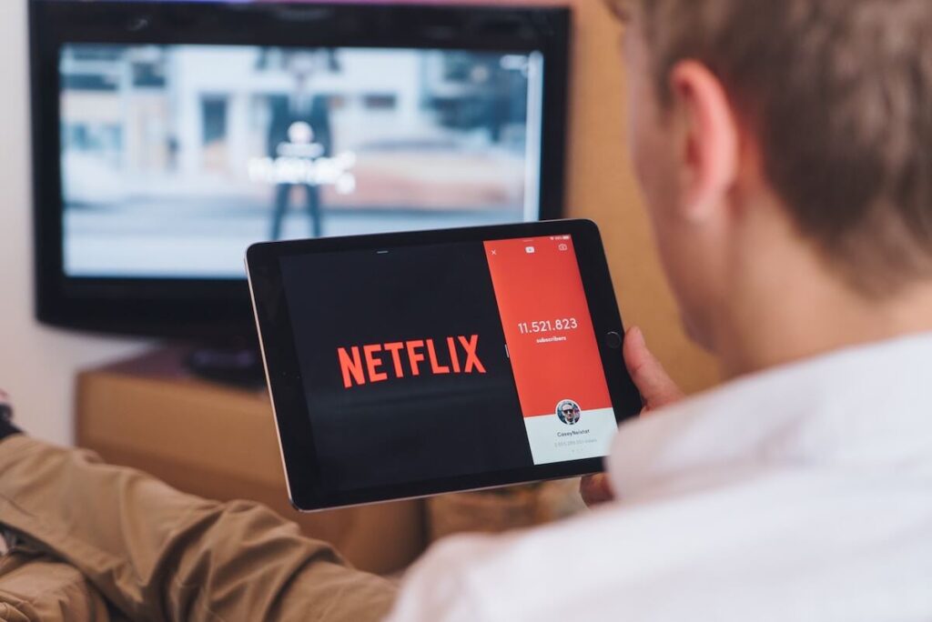 man watching netflix on tablet