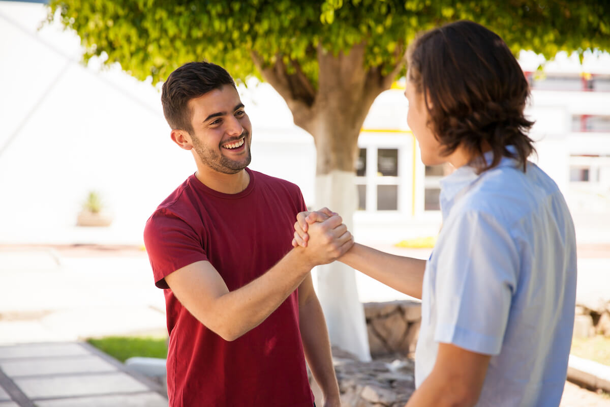 two male friends greeting each other