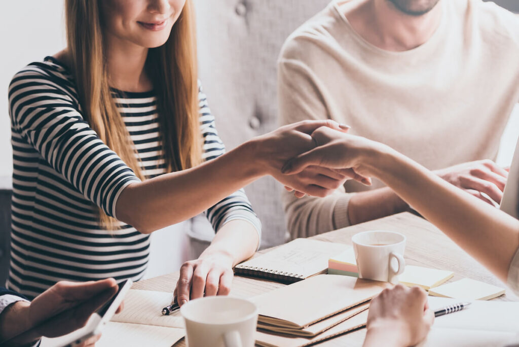 woman shaking the hand of new acquaintance