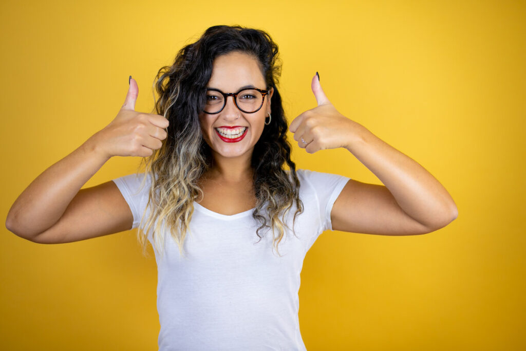 young woman doing ok signal with her thumbs
