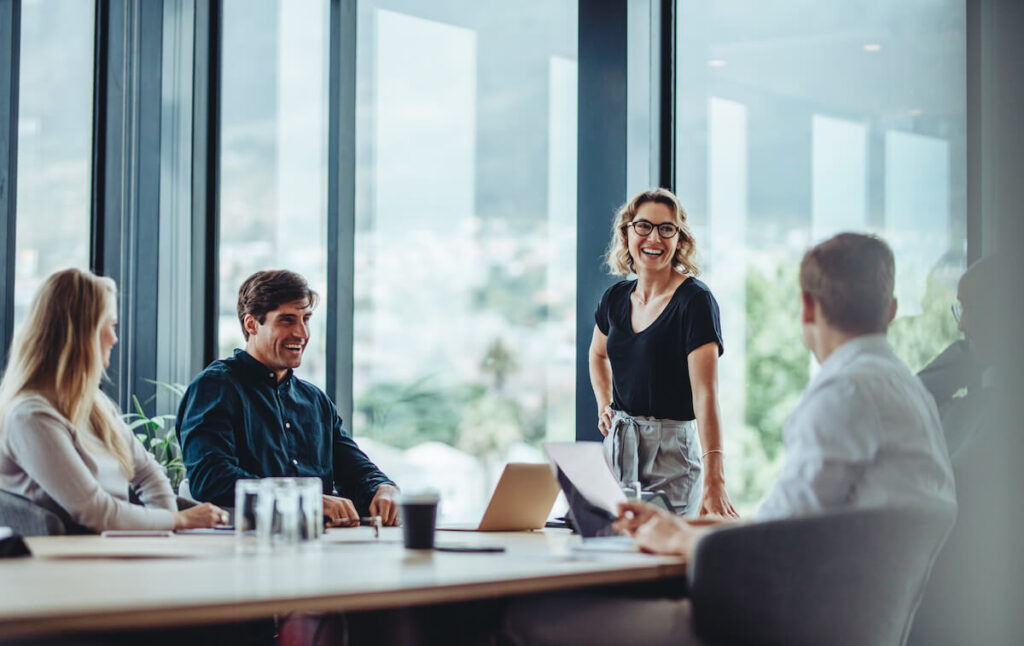 men and women having casual discussion during meeting in conference room