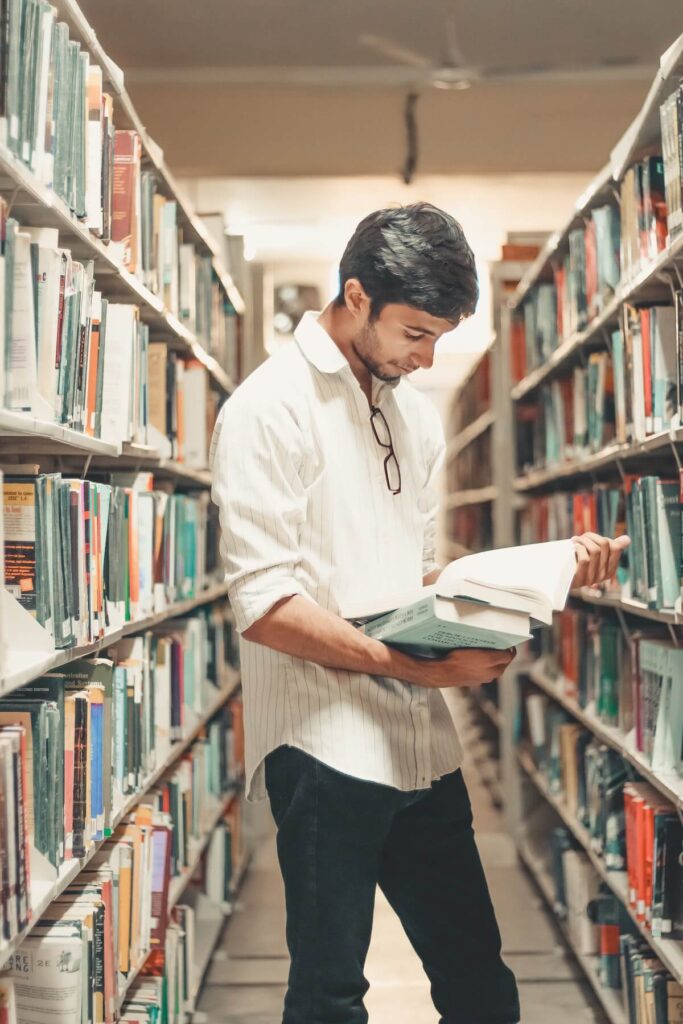 man reading a book in a library