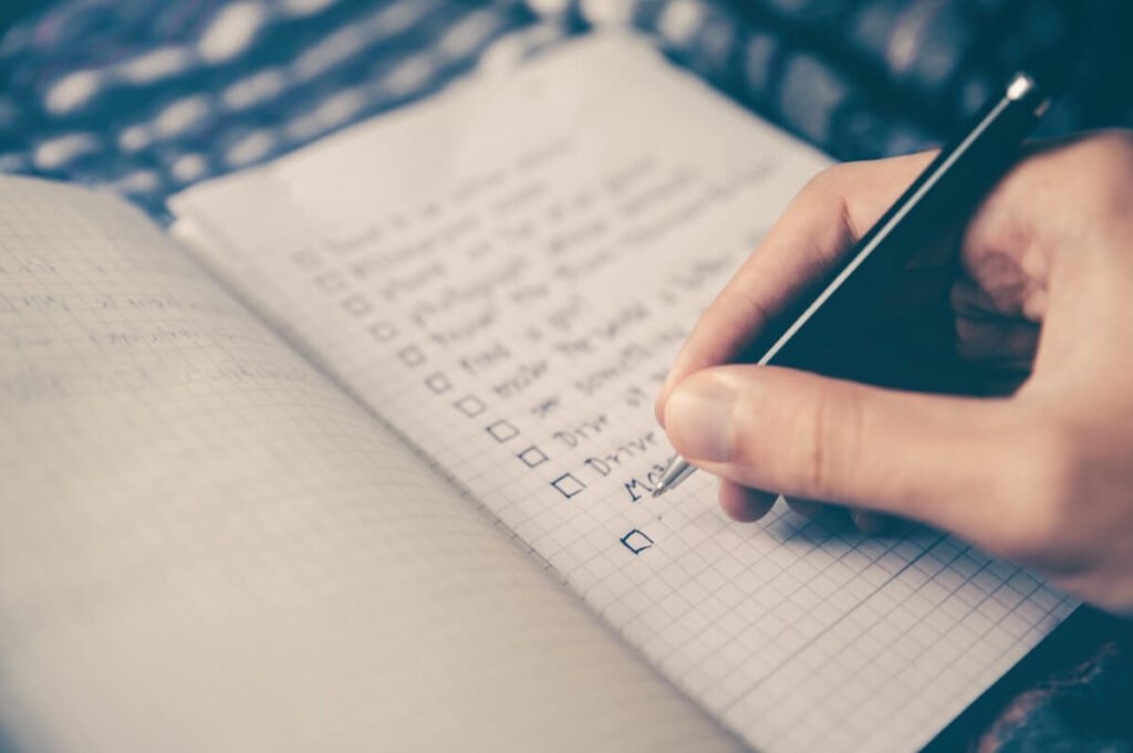 hand writing plans on notebook