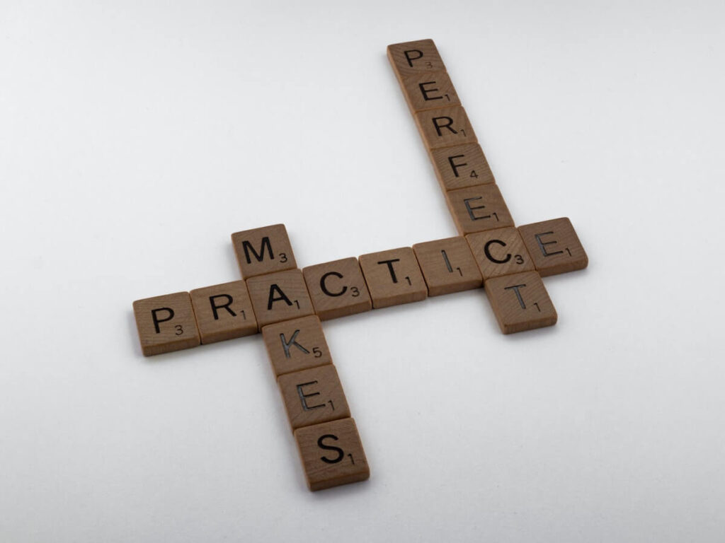 practice makes perfect spelled out in wooden blocks