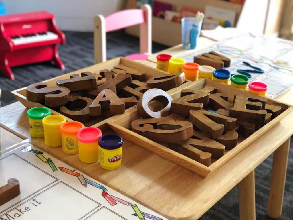wooden alphabet and play doh at school