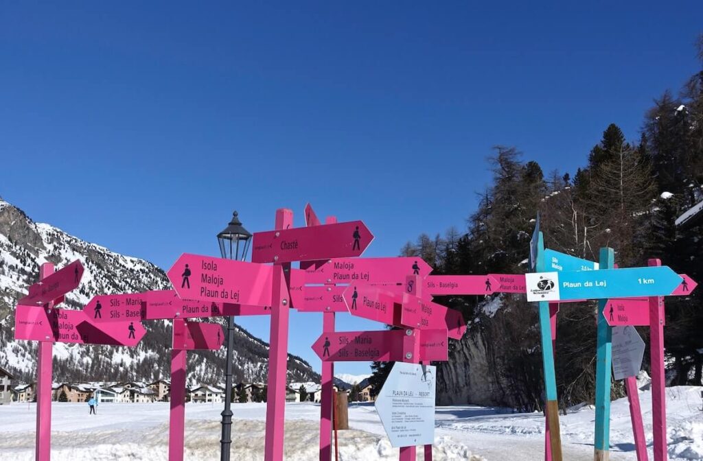 Road signs over iced lake of Sankt Moritz, Switzerland
