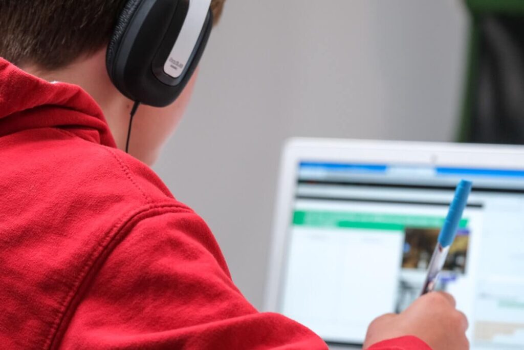 child with headphones studying