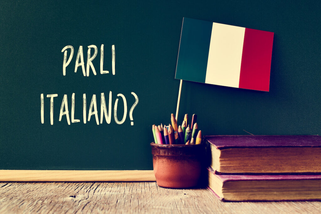 a chalkboard with the question parli italiano?