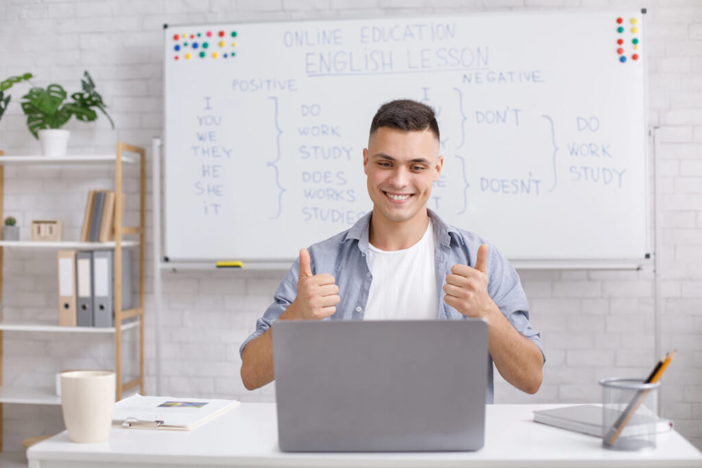 male online teacher explaining English verbs