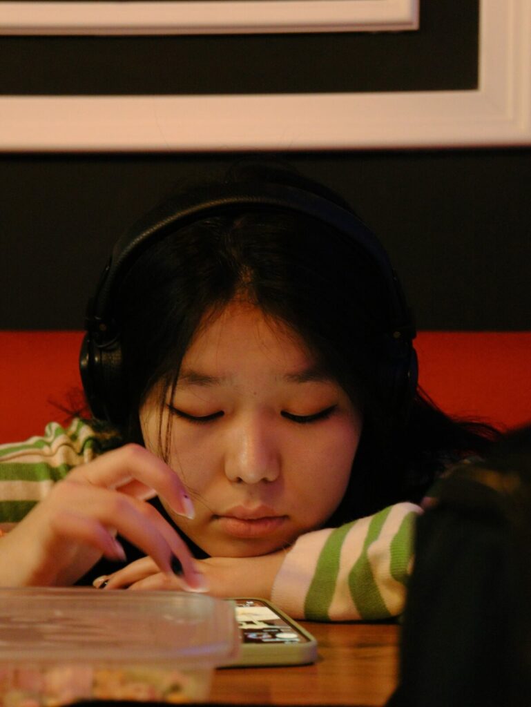 girl wearing headphones and using phone
