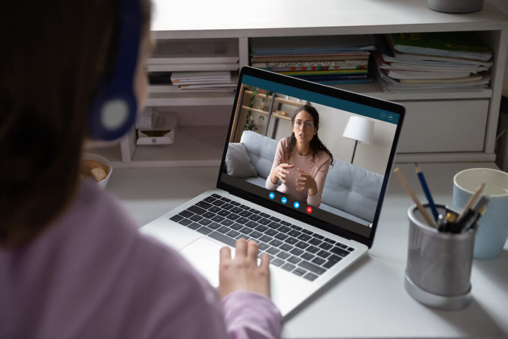 tutor gives remote class teaching teenage pupil elearning from home