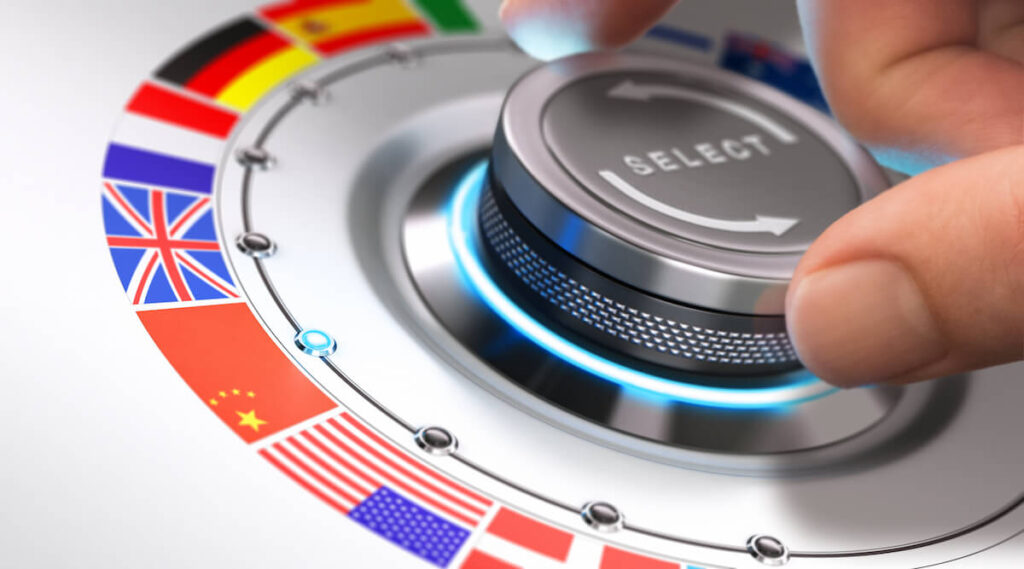 Hand turning a selection knob with many different flags around it