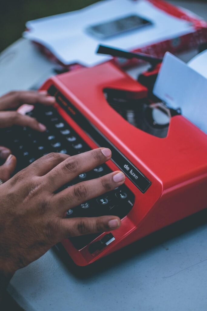 person writes on typewriter