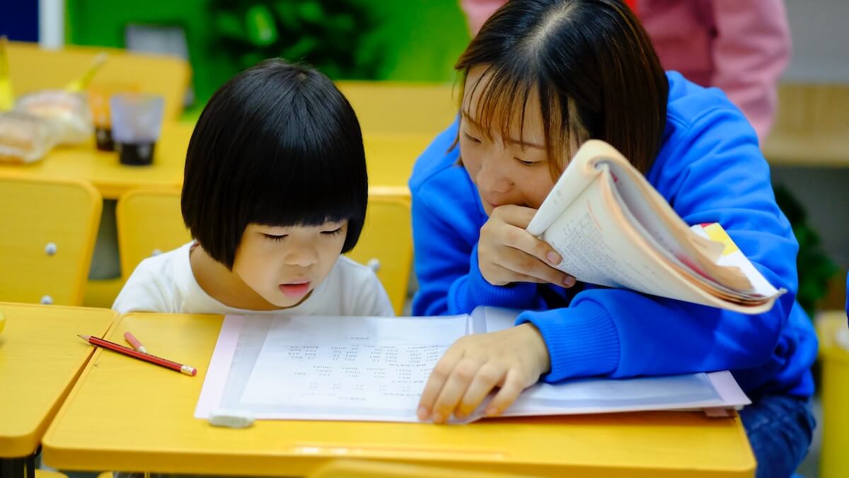 tutor teaching Chinese to a young student