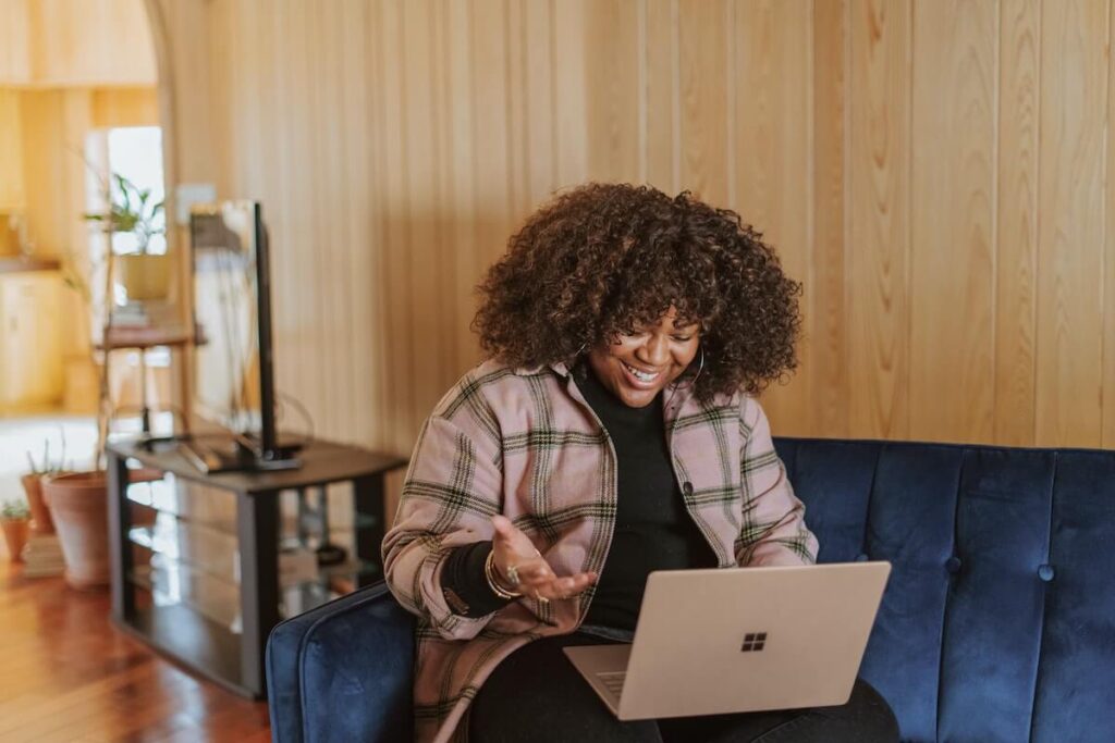 woman using computer and laughing