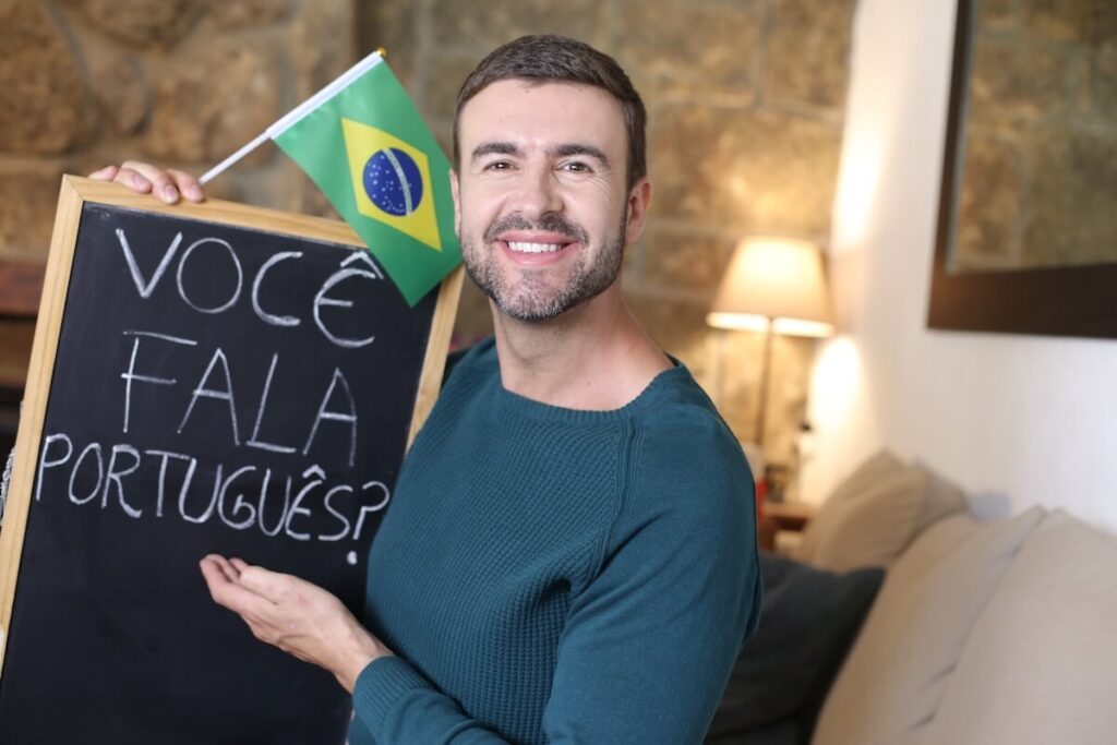 Portuguese teacher holding blackboard and Brazilian flag