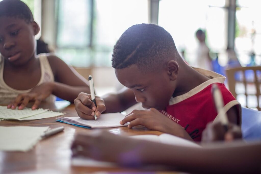 boy writing in classroom setting
