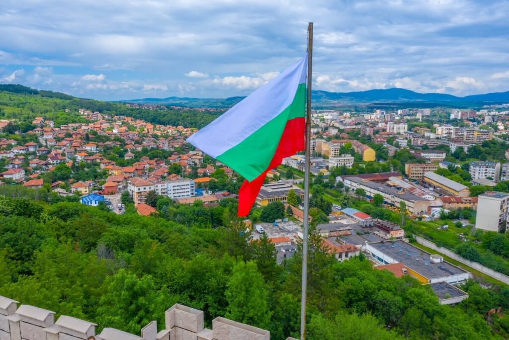 Aerial view of Bulgarian town Pernik and Bulgarian flag