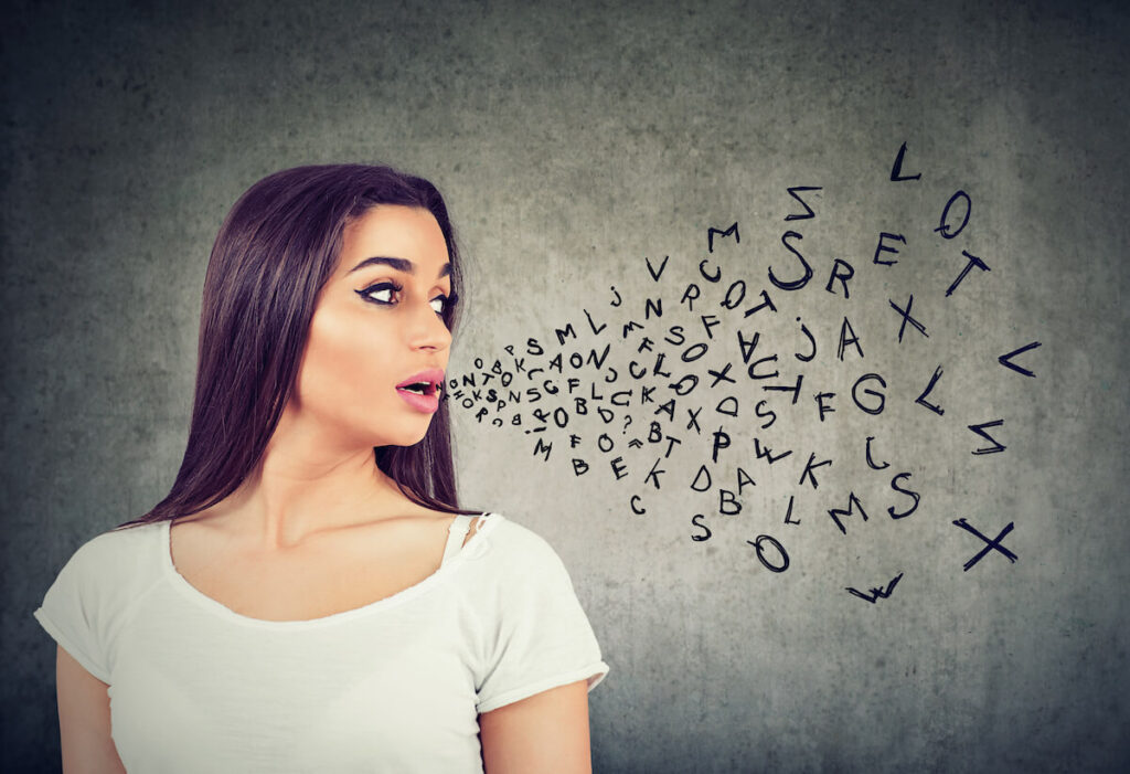 Woman talking with alphabet letters coming out of her mouth
