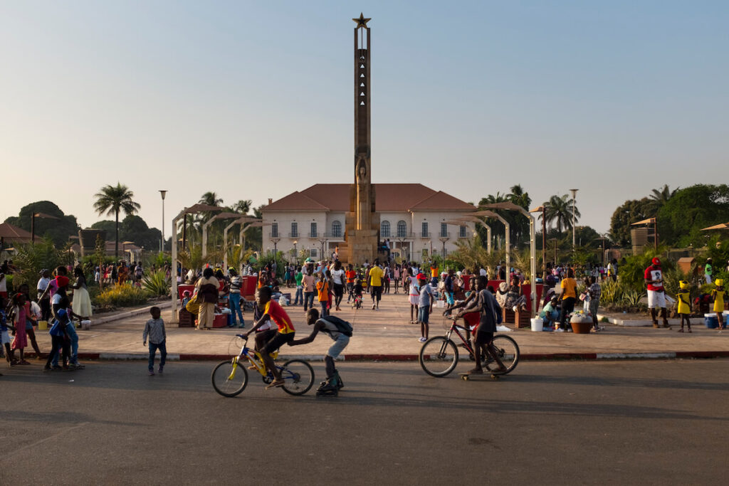 Street scene in the city of Bissau with people at the Praca dos Herois Nacionais, in Guinea-Bissau, West Africa