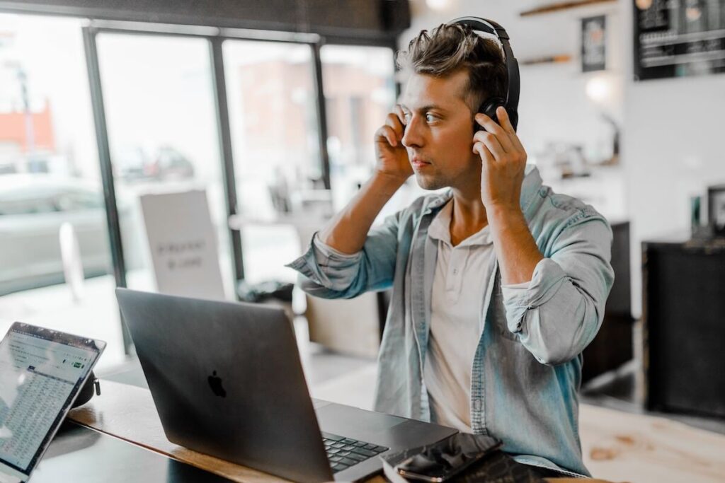 man adjusting headphones