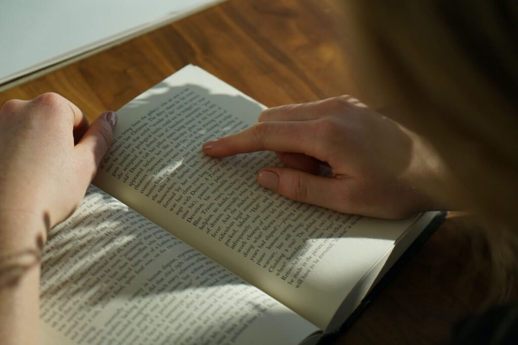 man attentively reading book