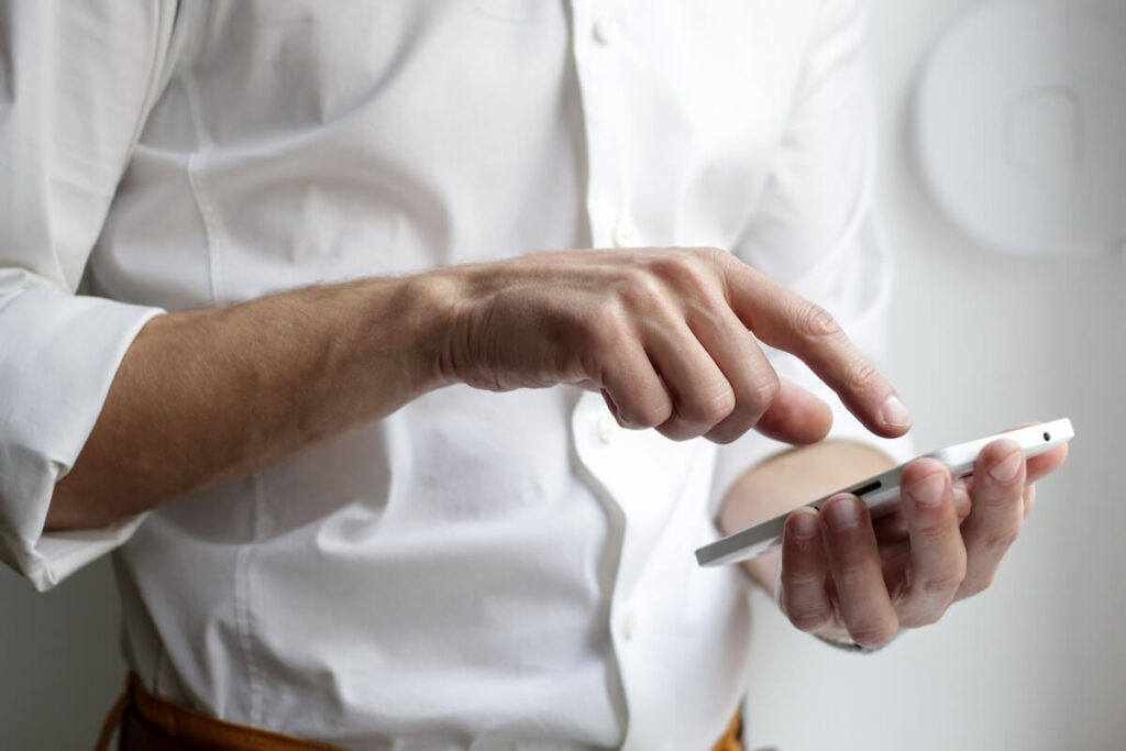 man tapping on phone