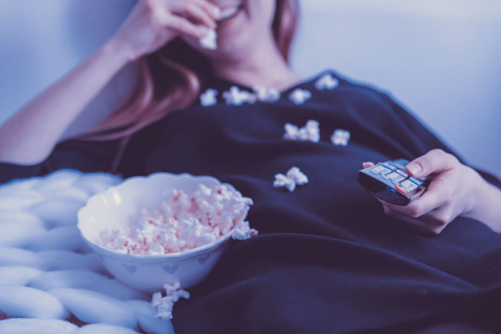 woman makes a mess eating popcorn