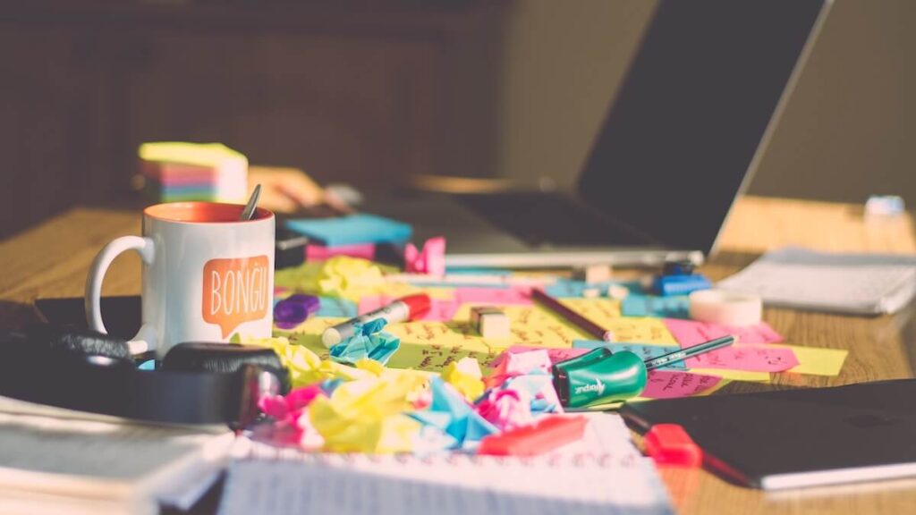 messy desk with assorted items