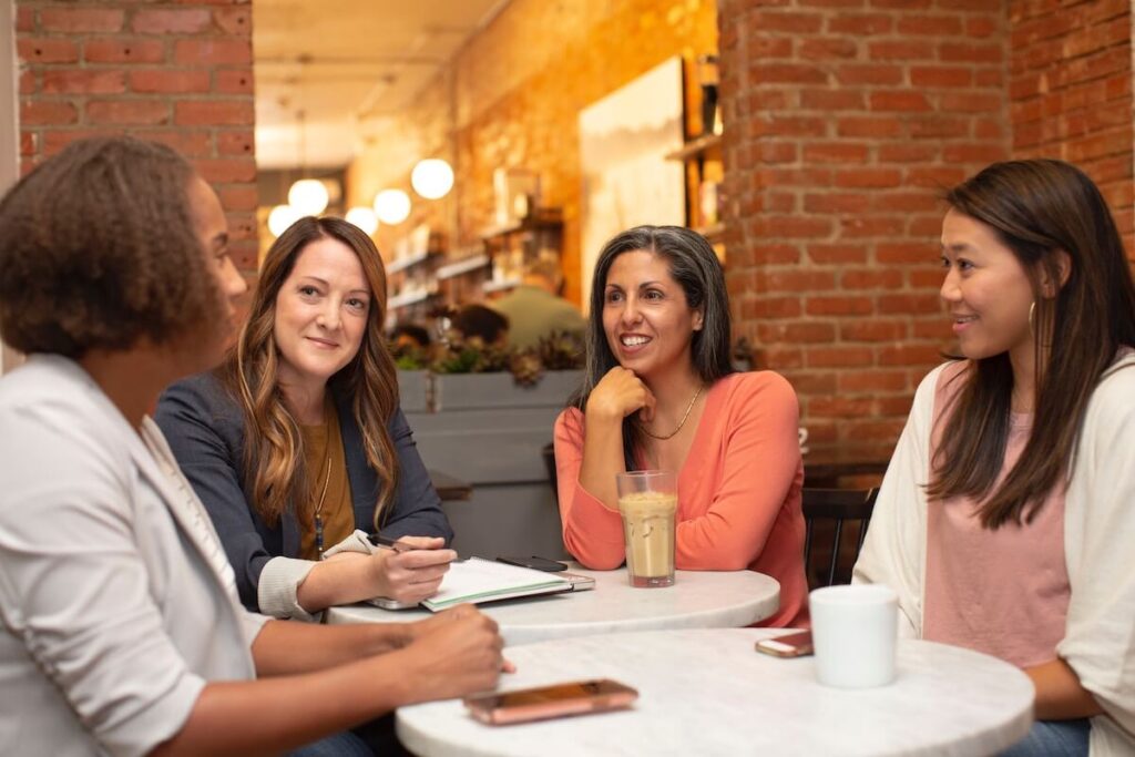 middle aged women talk in casual setting