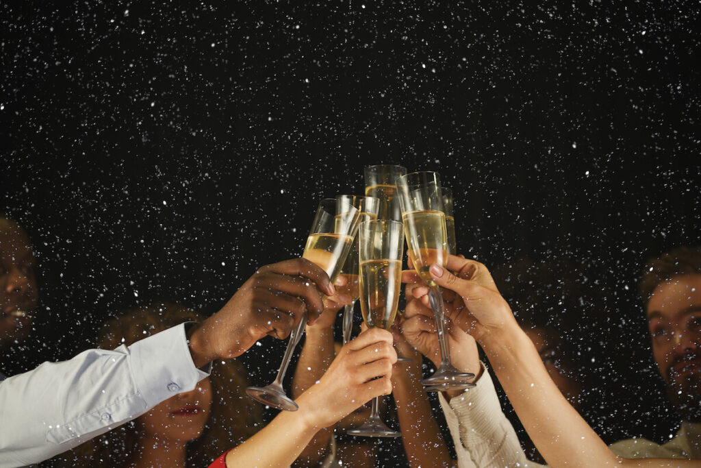 Young people toasting with flutes of champagne